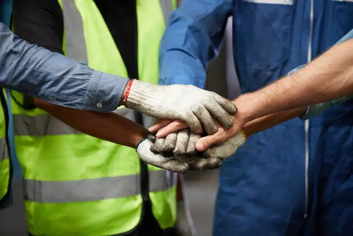 Employee motivation as employeess pile hands before their shift.