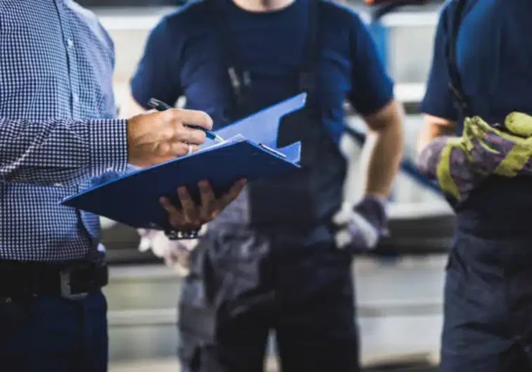 Blue Collar manager holding clipboard, giving timely feedback