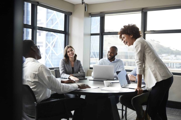 Business workers become a better leader in a group meeting.