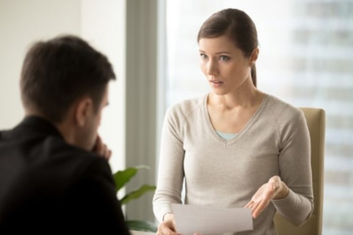 Irritated businesswoman holding paper, disagrees with bad contract terms, refuses to sign document, has questions claims to agreement conditions, boss dissatisfied with report or written work result