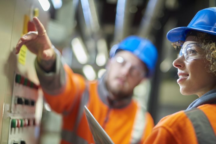 Types of employee engagement with manager in caution gear and hard hats training an individual in a boiler room.