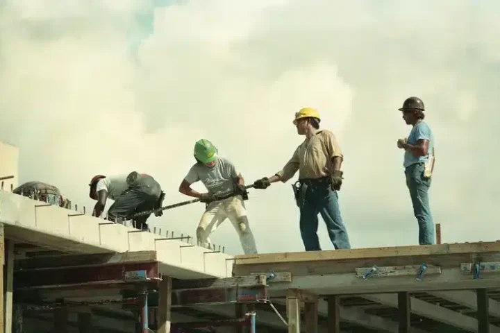 Group of employees with one employee underperformance as he stands asides.