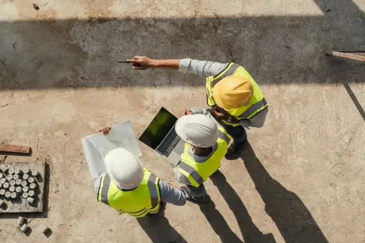 Workers going over plans together in a positive work environment.